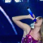 Taylor Swift holds a light saber style prop as bicycles and cars go by her in amazing visual show on stage during first weekend of her tour in Arizona