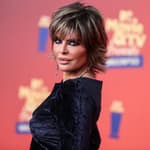 Lisa Rinna posing in a black dress during the MTV Movie Awards.