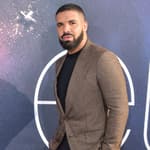 Drake posing on the red carpet.