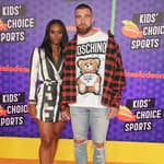 Tavis Kelce and Kayla Nicole posing together on the red carpet.