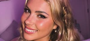 Andreea Dragoi smiles while taking a selfie.
