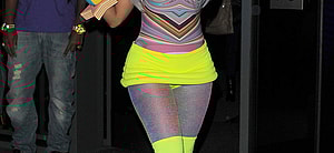 Nicki Minaj leaving the W Hotel in Leicester Square The singer showed off her new blue hair and wore a multicoloured top neon yellow hot pants tights and neon yellow boots