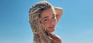 Olivia Dunne poses for the camera on a boat.