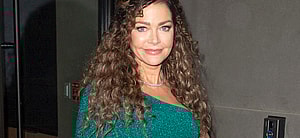 Denise Richards rocks a green one shouldered dress as she exits studios in NYC