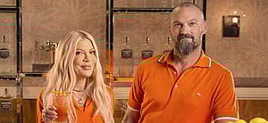 Tori Spelling and Brian Austin Green drinking a cocktail