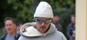 Justin Bieber carries a coffee in a strange way