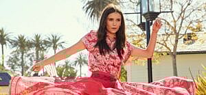 A photo of Nina Dobrev in a pink dress