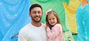A photo showing Tony Raines and his daughter laughing beautifully to the camera.
