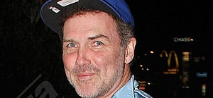 Norm MacDonald in a flat bill hat