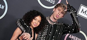 Machine Gun Kelly and daughter pose for the camera.