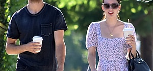 Garrett Hedlund and Emma Roberts walking.