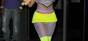 Nicki Minaj leaving the W Hotel in Leicester Square The singer showed off her new blue hair and wore a multicoloured top neon yellow hot pants tights and neon yellow boots
