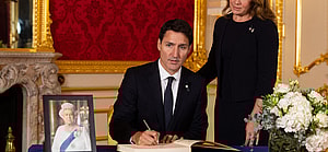 Prime Minister of Canada Justin Trudeau and his wife Sophe Trudeau sign a book of condolence at Lancaster House in London following the death of Queen Elizabeth II