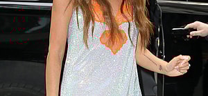 Chrissy Teigen wears a mini dress while arriving back at her hotel in New York City