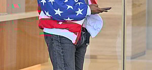 Kanye West heads to a meeting after heading to church wearing an American flag jacket