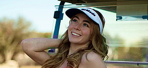 Grace Charis poses against a golf cart