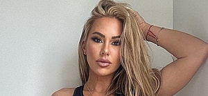 Kindly Myers in a black sports bra and leggings