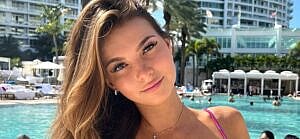 Grace Boor poses poolside in her pink bikini.