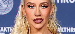 Christina Aguilera wearing Dolce and Gabbana with David Yurman earrings arrives at the 11th Annual Breakthrough Prize Ceremony 2025