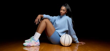 Angel Reese posing with new edition of her signature shoe.