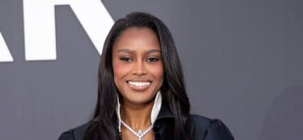 Ciara Miller posing on the red carpet.