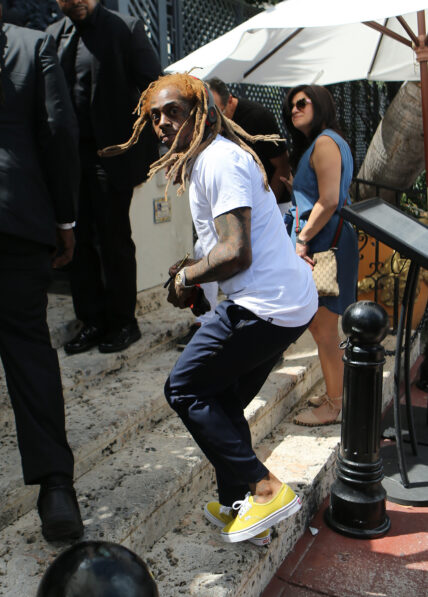 Rapper Lil Wayne sports yellow dreadlocks as he arrives to the wedding of rapper 2 Chainz