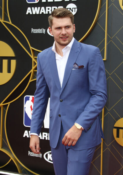 Luka Doncic smiling on the red carpet.
