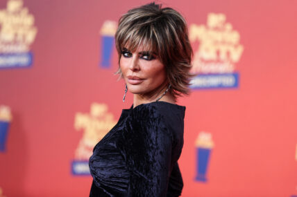 Lisa Rinna posing in a black dress during the MTV Movie Awards.