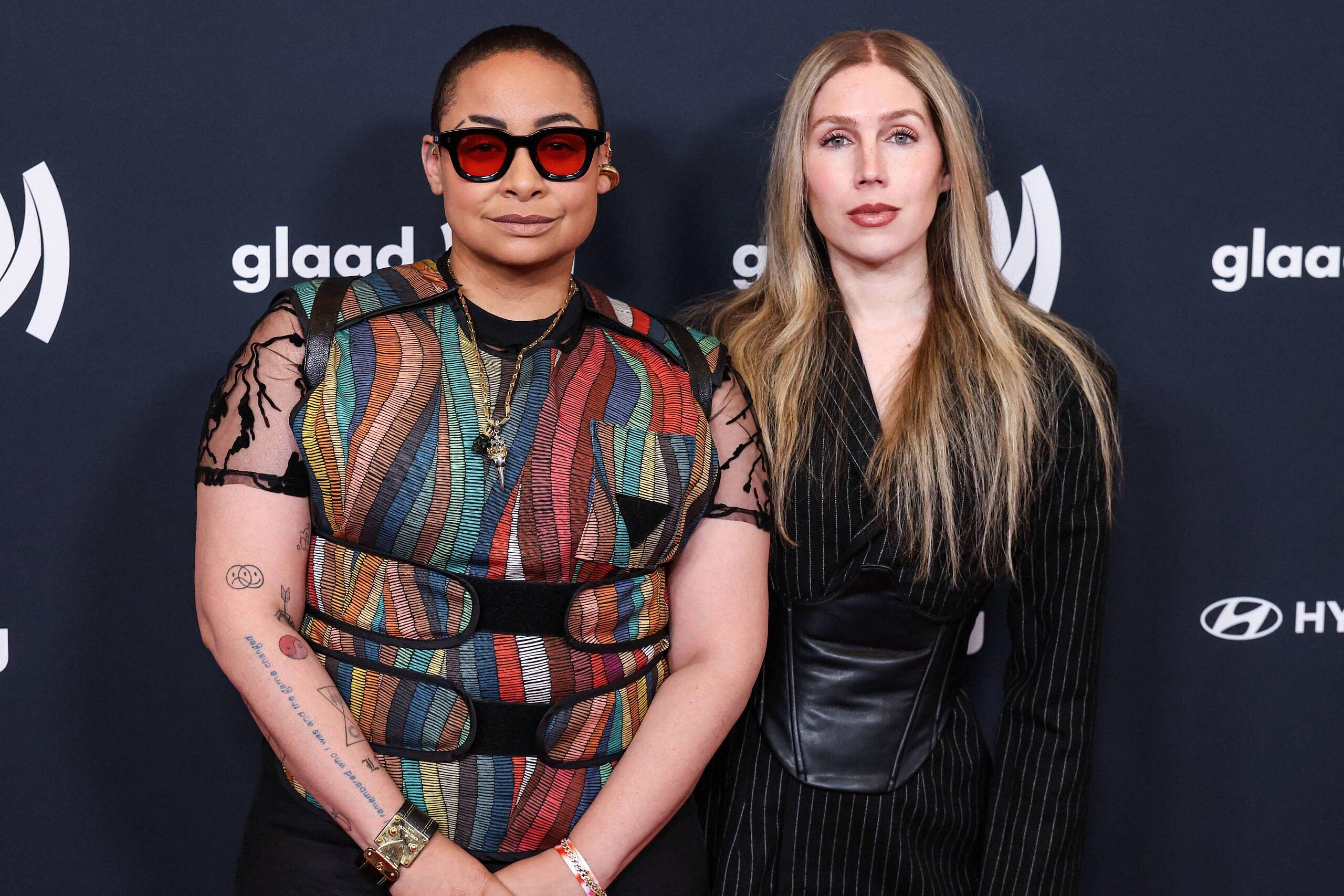 ‘Bachelorette’ Alum Speaks Out After Raven-Symoné’s Comment On ‘Blackness’ 3 Raven Symoné and her wife posing on red carpet.
