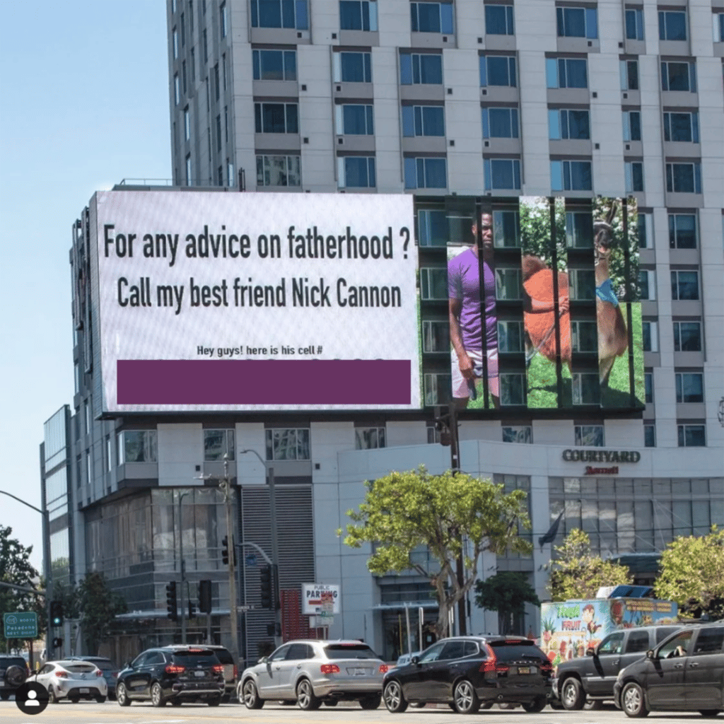 Billboard advertisement about fatherhood advice referencing Nick Cannon with a phone number obscured