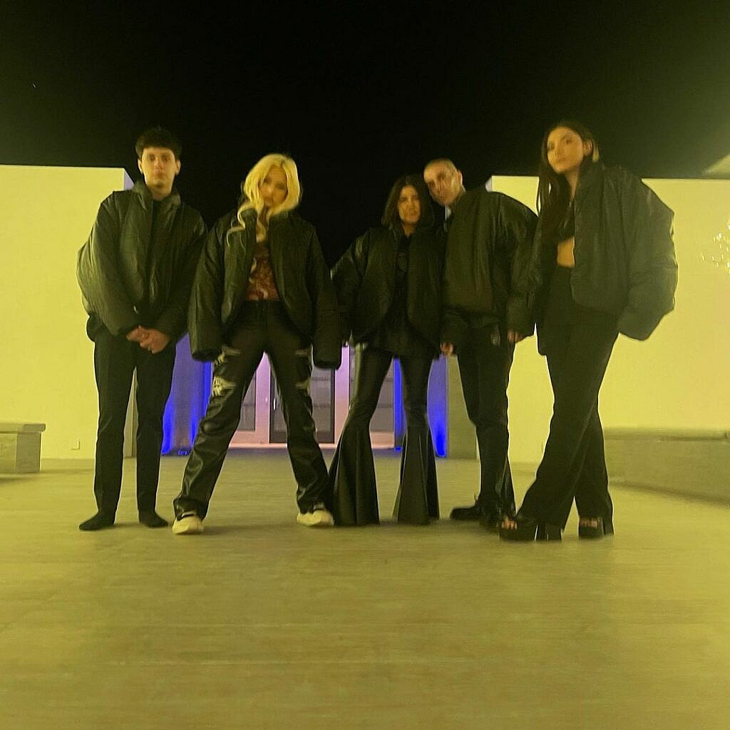 Kourtney Kardashian with Travis Barker and his kids posing for the camera.