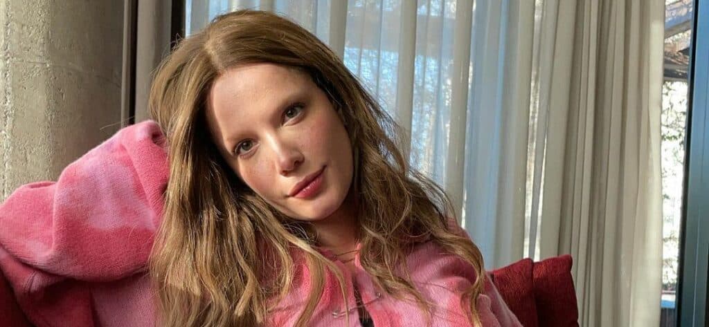 Halsey wearing a pink sweater and cheetah print dress