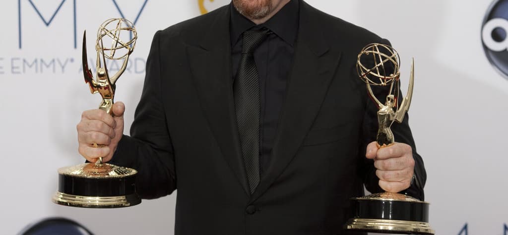 Louis C.K. holding two Emmy awards