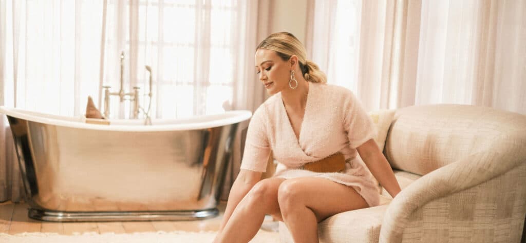 Hilary Duff shows off her shapely legs and dazzles in festive tinsel Smash Tess romper