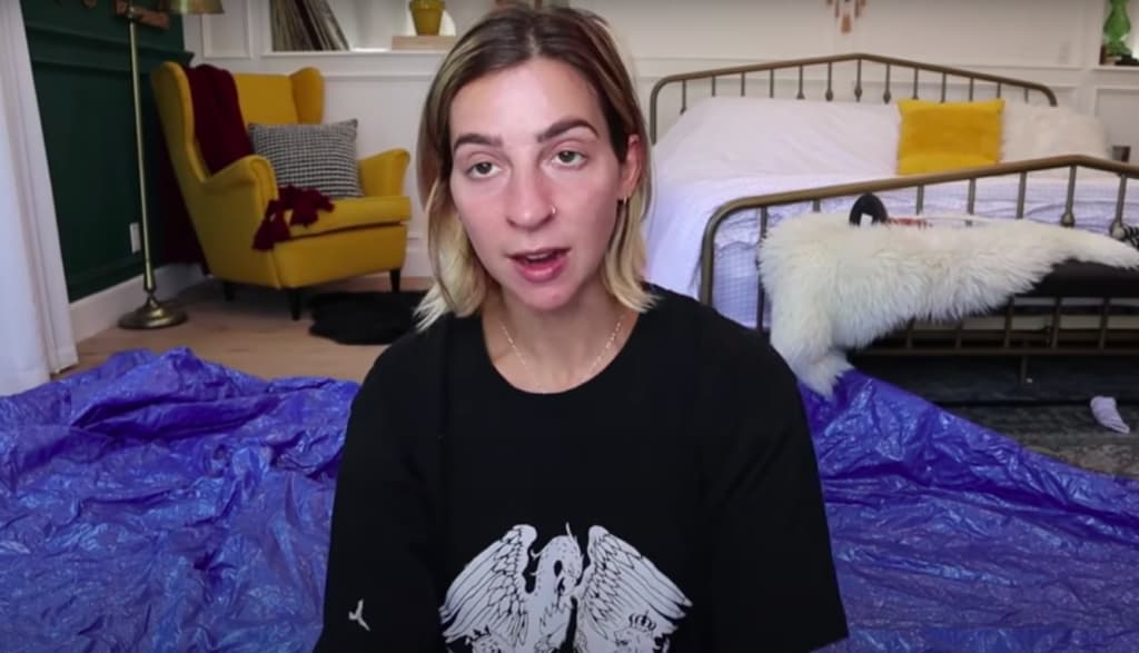 Gabbie Hanna sitting on a bed