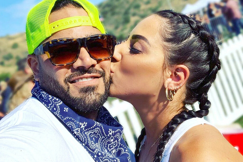 woman kisses a man on the cheek