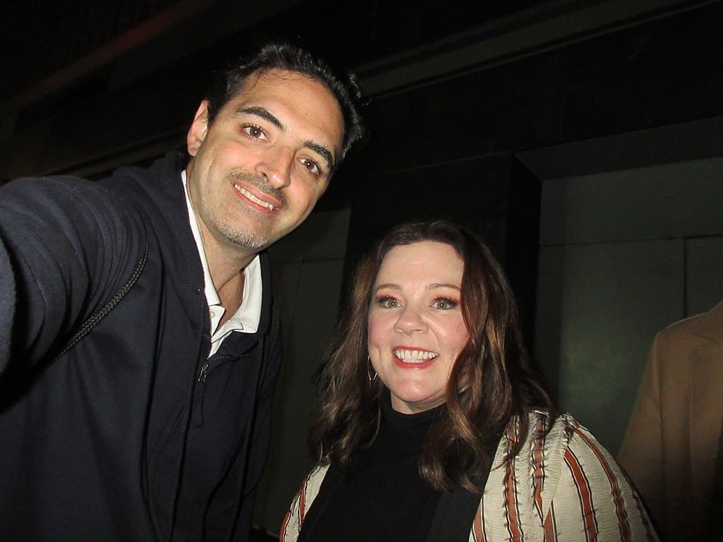 Two people smiling at a social event