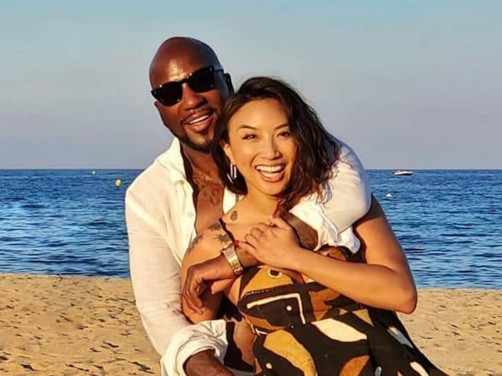Jeannie Mai and a man smiling together on a beach