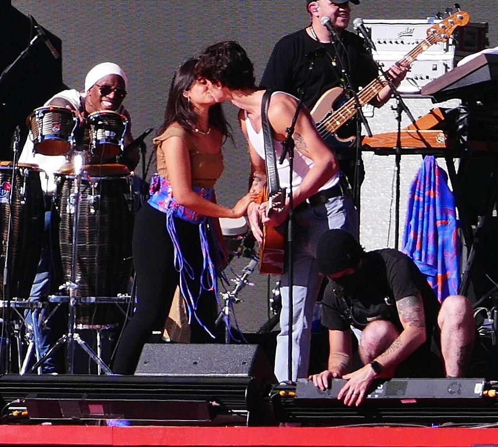 Camila Cabello and Shawn Mendes share multiple kisses as they laugh as stagehand keeps building the set during their romantic soundcheck as fans join in on the laughs as they perform at Global Citizens in the hot sun day before massive event in NYC