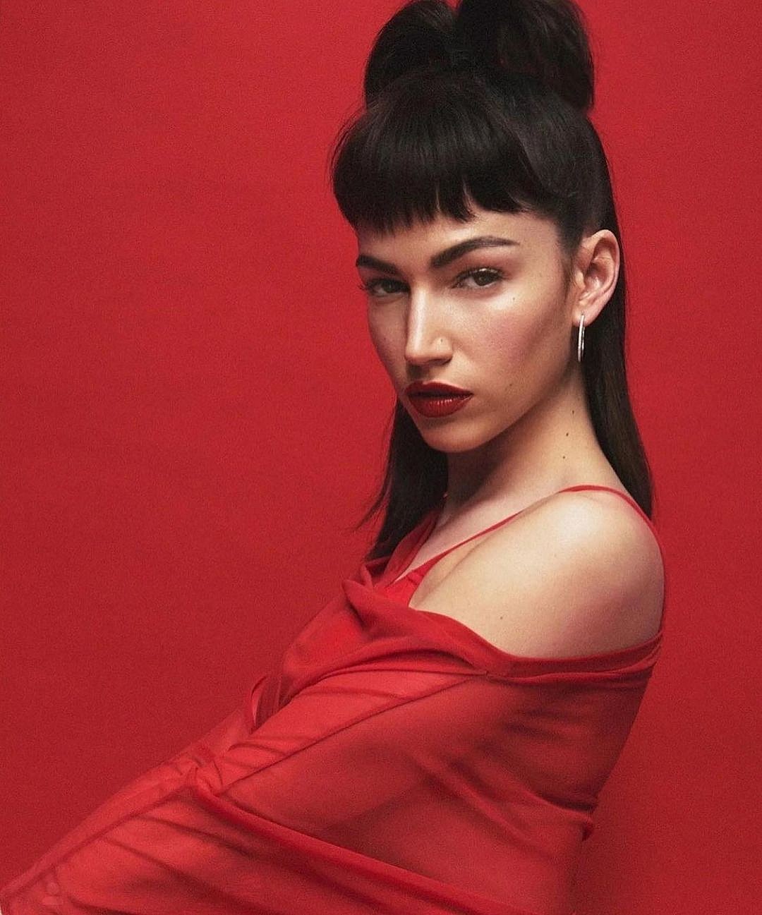 A photo showing a cast of 'Money Heist' named Tokyo, in a red outfit.