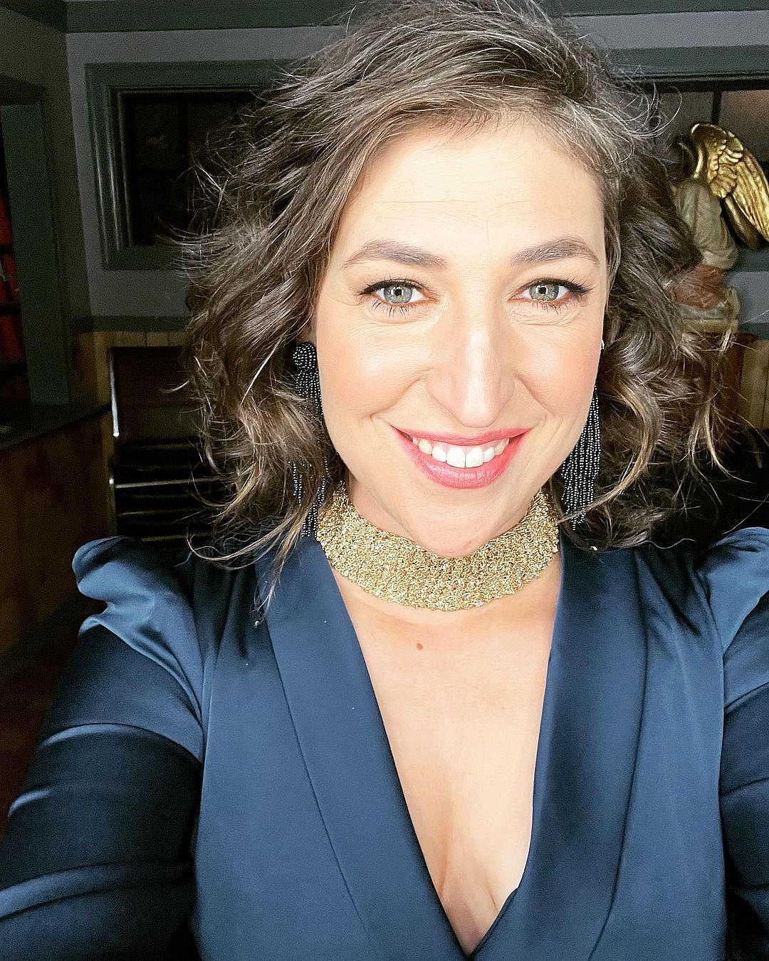 An up-close photo showing Mayim Bialik with a cute smile on her face.
