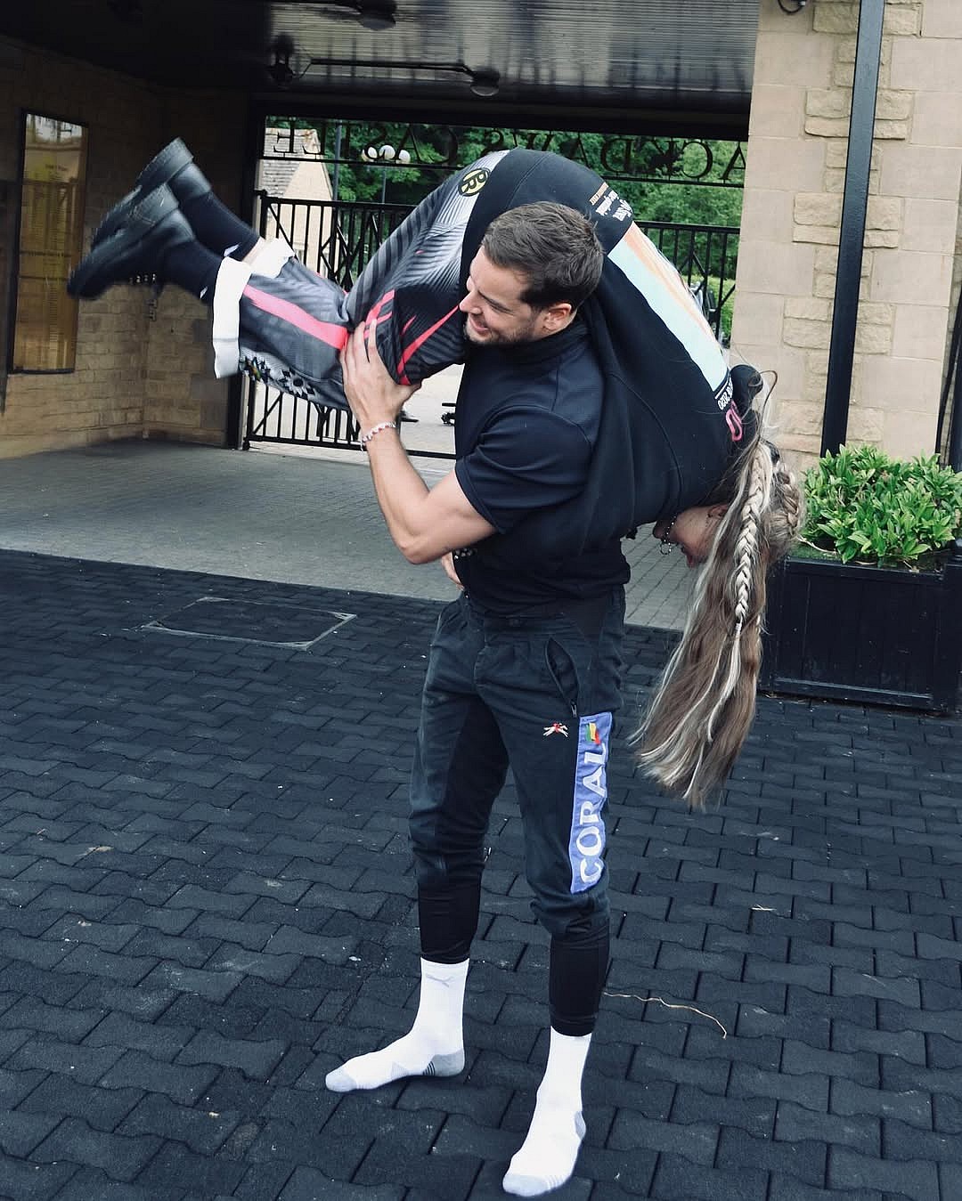 Chris Hughes holding JoJo Siwa