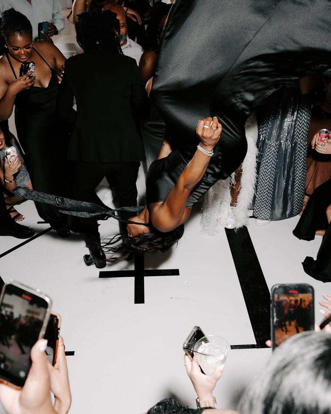 Simone Biles backflips in a dress at a wedding
