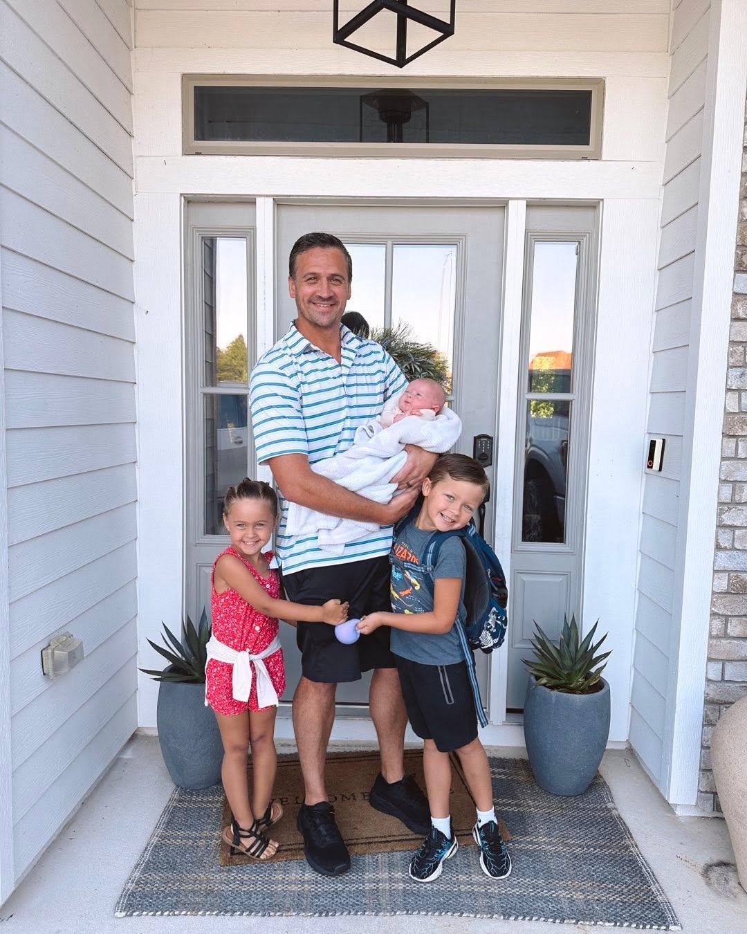 Ryan Lochte posing with his children. 
