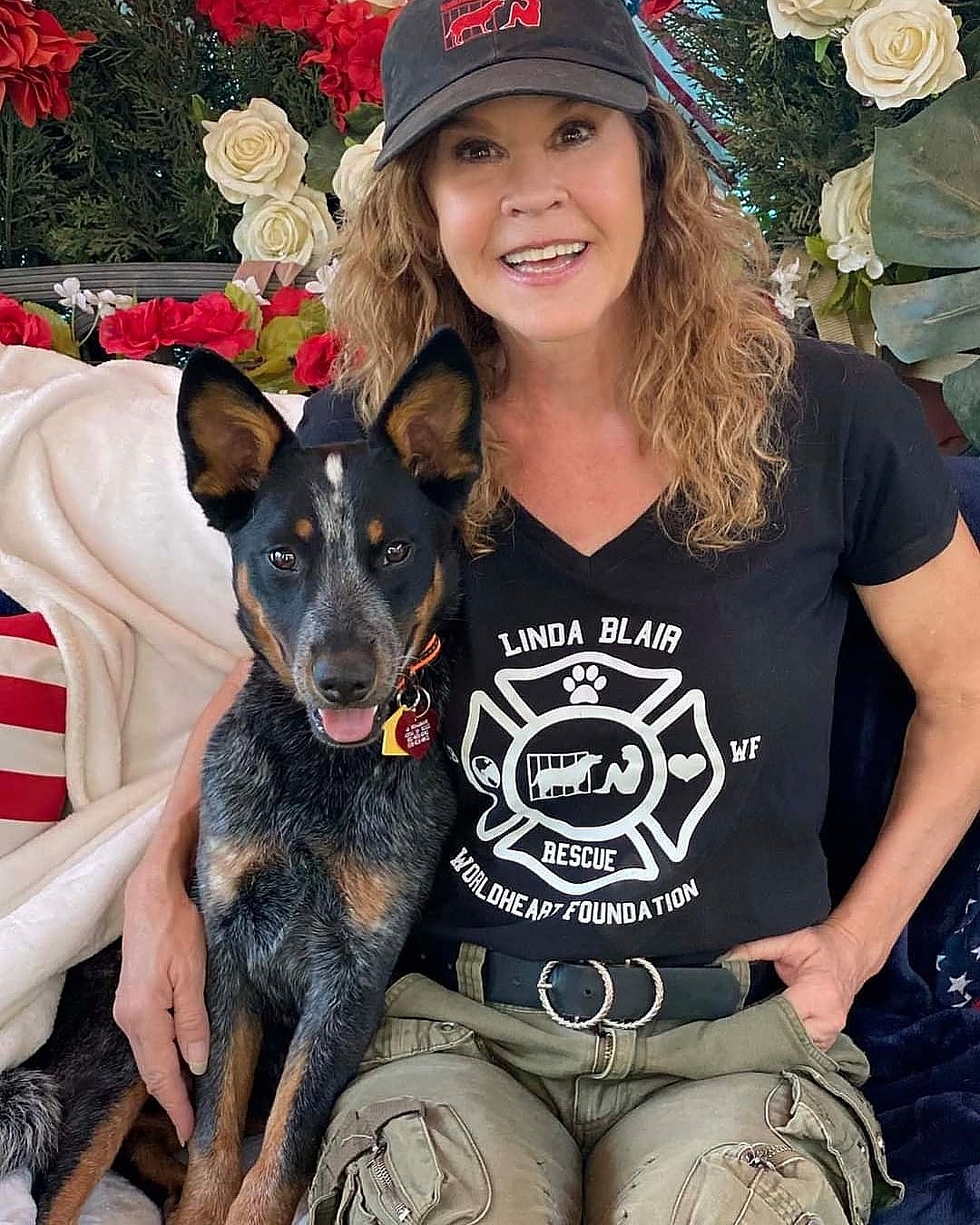 A photo showing Linda Blair posing with her dog.