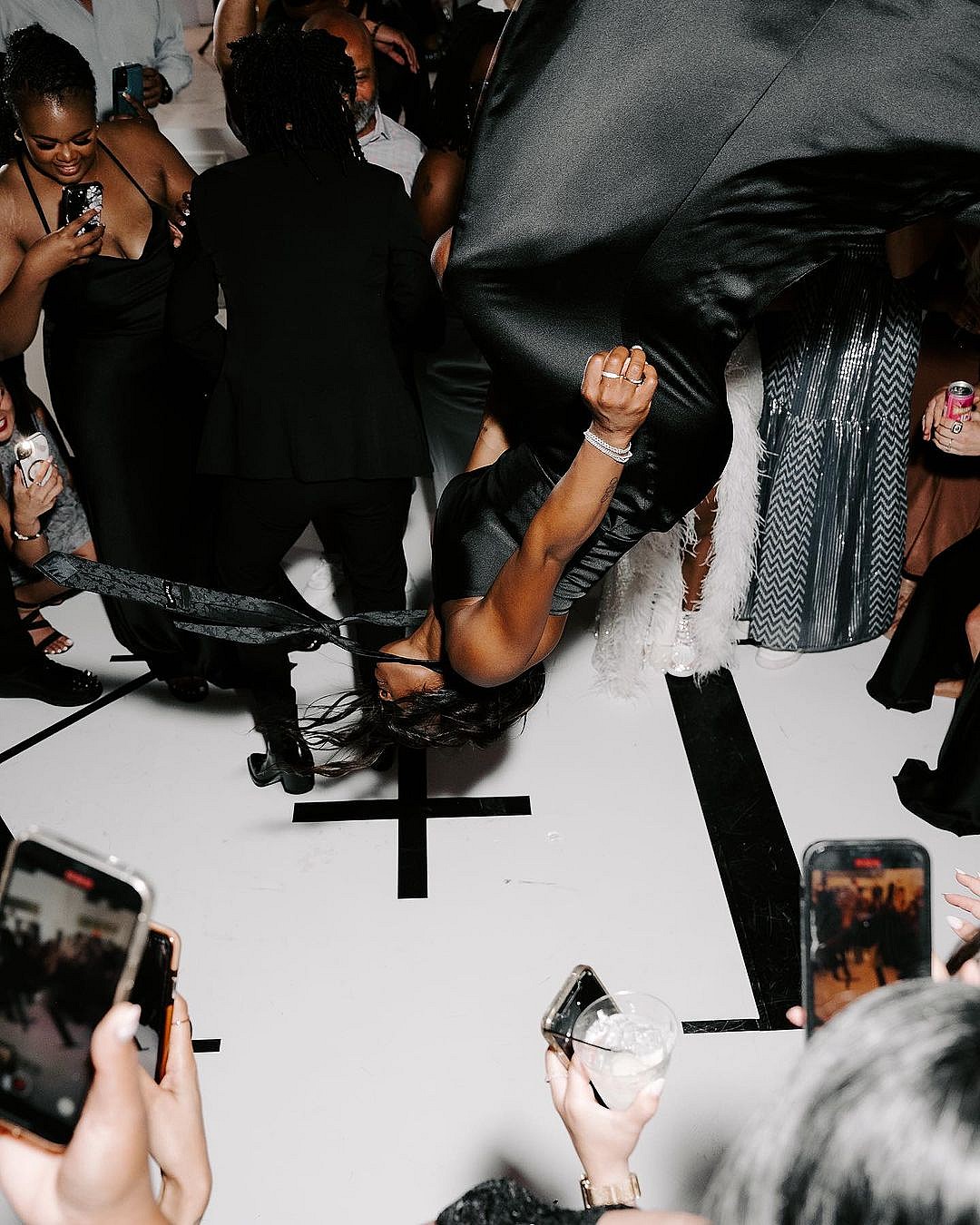 Simone Biles backflips in a dress at a wedding