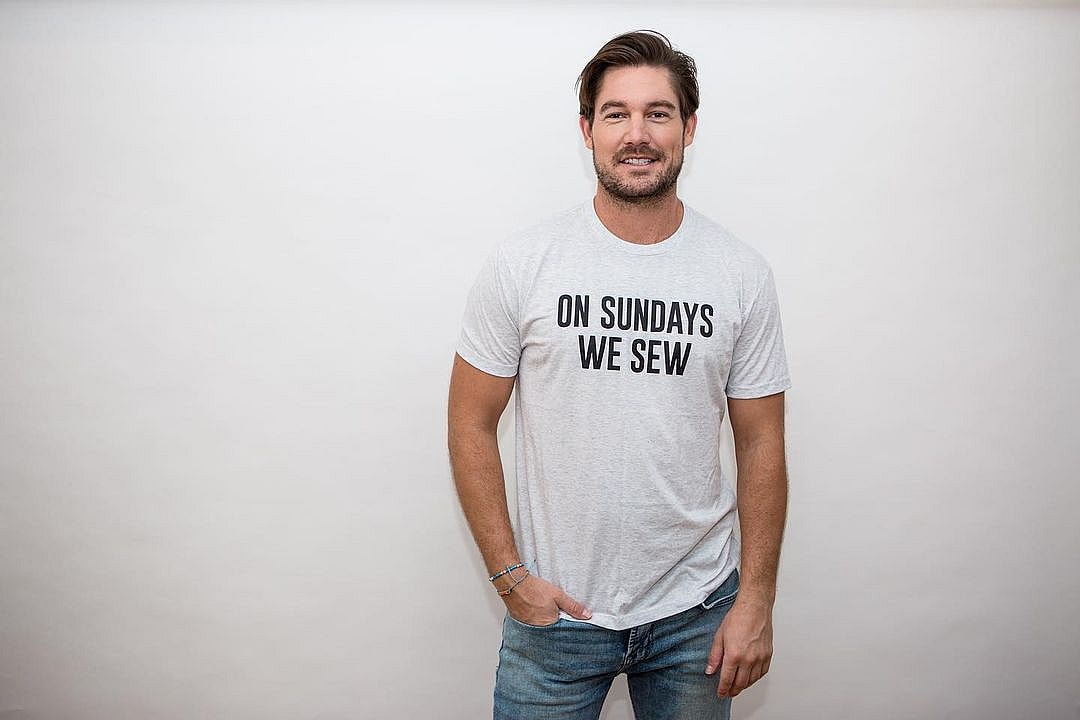 A photo showing Craig Conover in a white Tee and denim pant.
