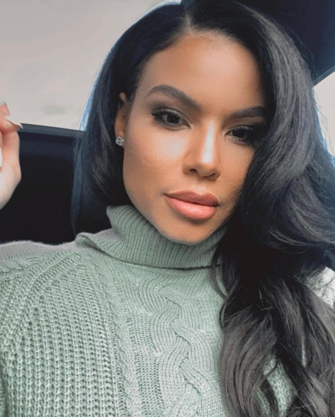 Mia Thornton wearing a light green turtleneck sweater in a close-up portrait