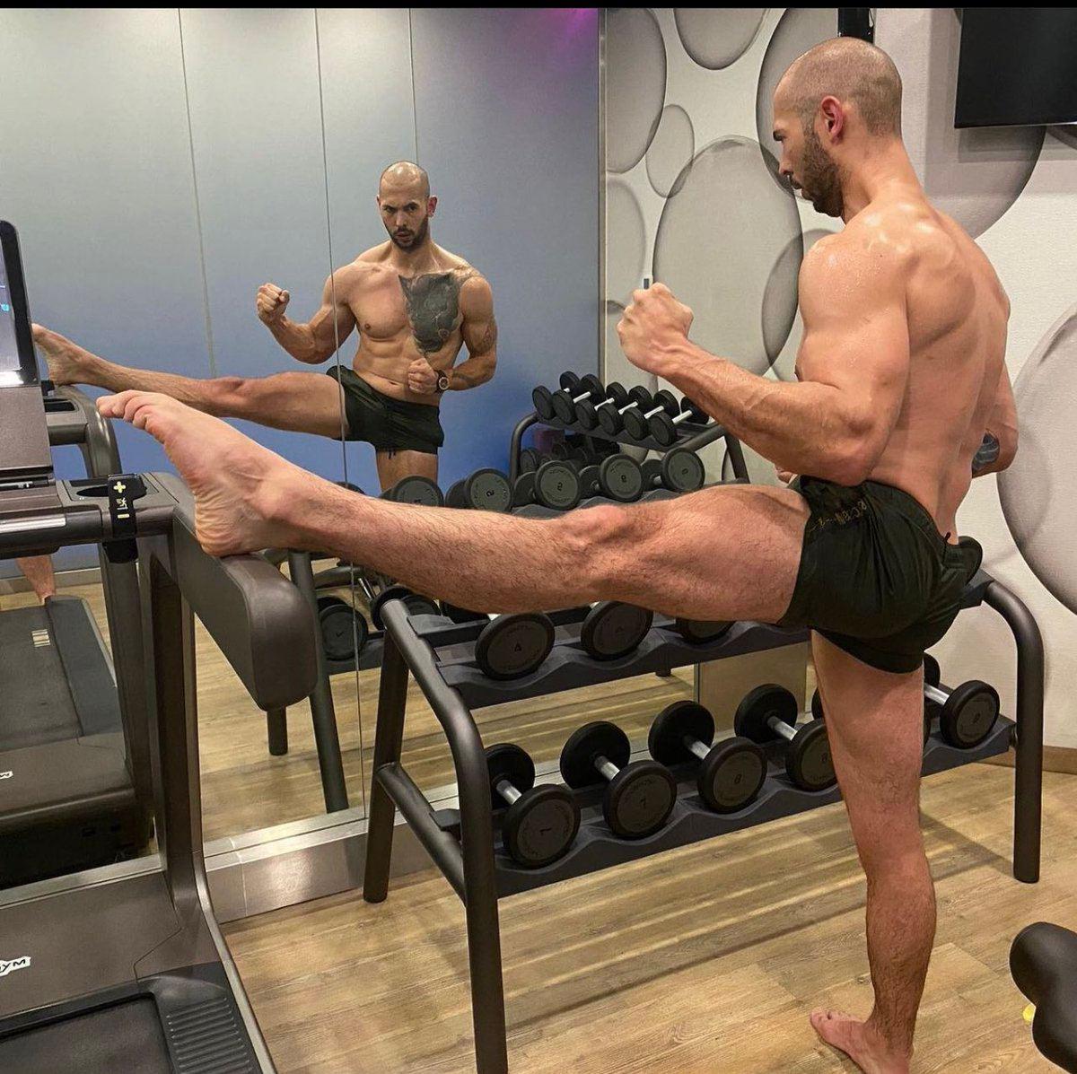 Andrew Tate stretching in the gym