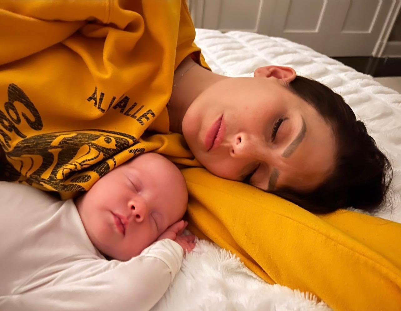 Hilaria sleeping with her newborn daughter
